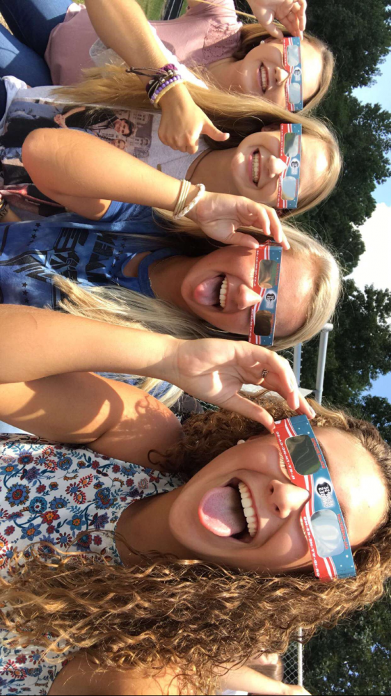 Junior Kensley Armstrong and sophomores Kaitlyn Prince, KC Weathers and Sydney Stryk have fun watching the eclipse.