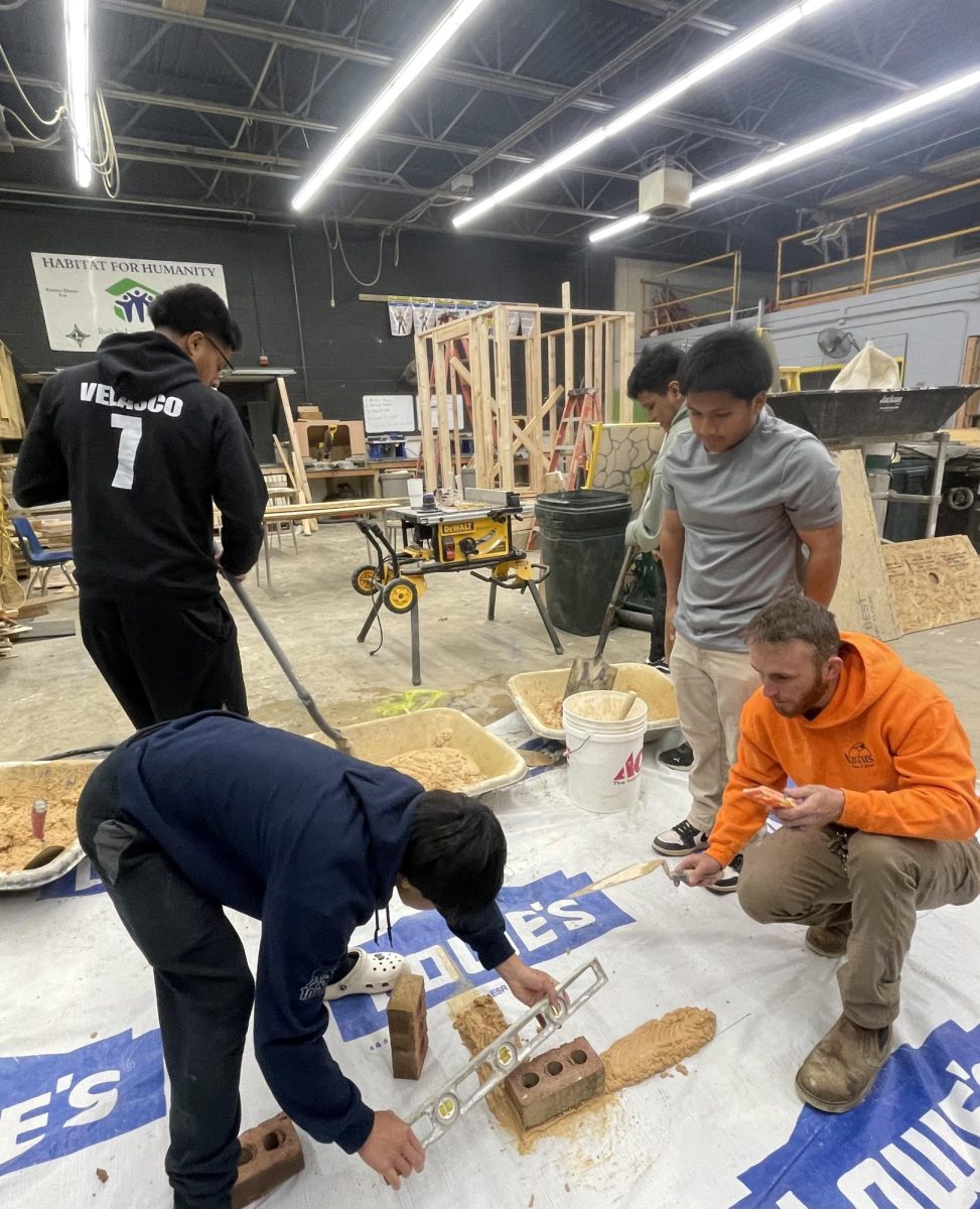 Building construction teacher Joseph Adams teaches a masonry unit.
