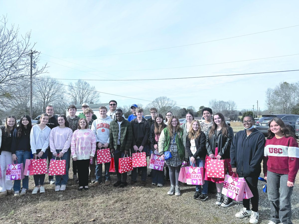 The National Honor Society spreads love by handing out their bags of love at the Laurens Memorial Home for the Aged.